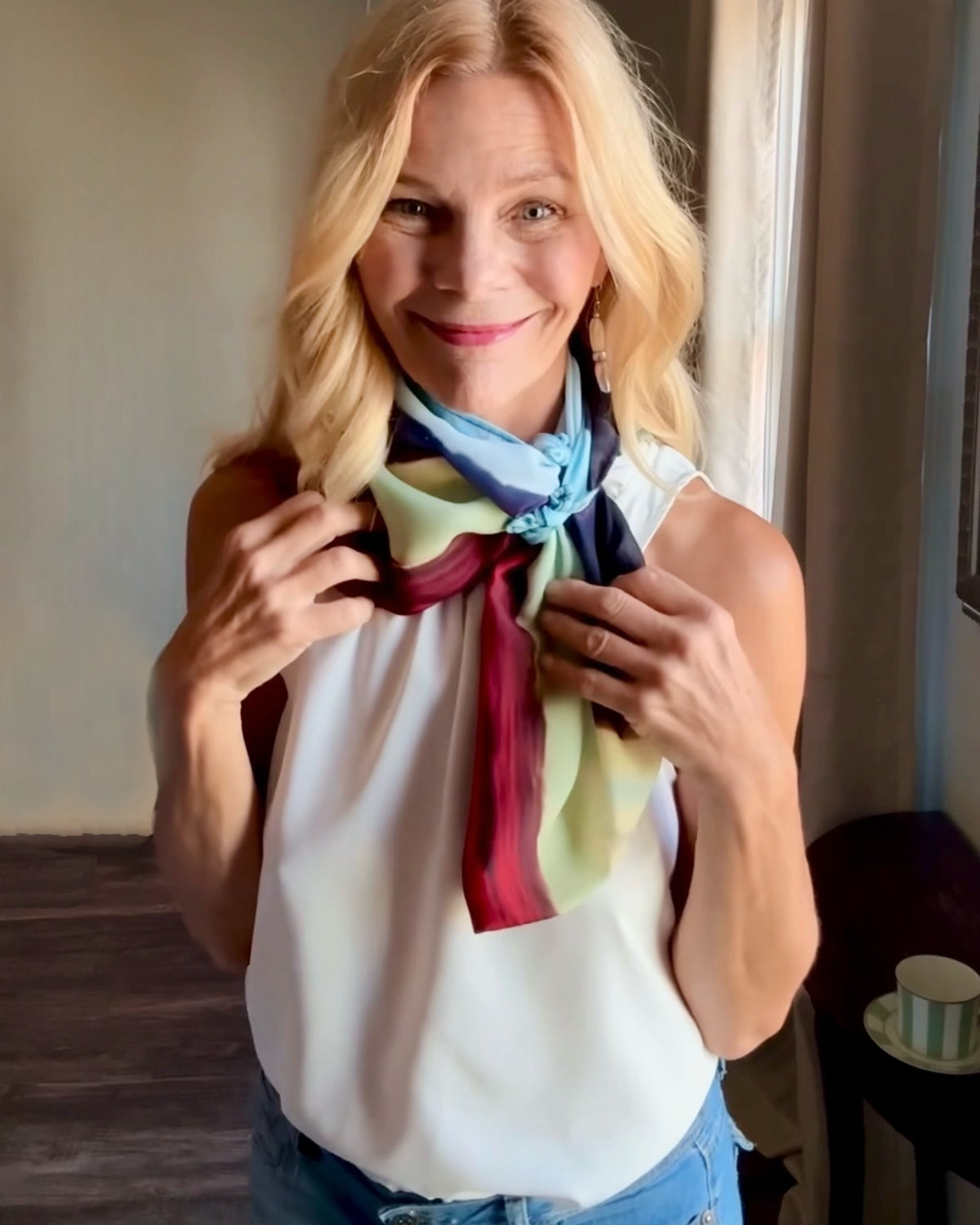 Layercake Scarf styling demonstration showing scarf slipping over shoulders with signature pre-tied design