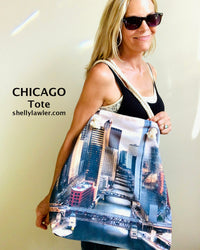 Woman holding a Chicago-themed tote bag with cityscape design on a plain background