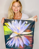 Designer Shelly Lawler holding Lotus tote bag with a water lily design