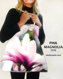 Person holding a pink magnolia tote bag with 'Pink Magnolia Tote' text and website URL.