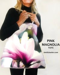 Person holding a pink magnolia tote bag with 'Pink Magnolia Tote' text and website URL.