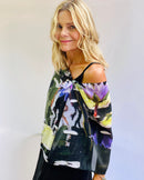 Dream scarf side view with signature pre-tied design, lightweight fabric worn off one shoulder showing waterlilies pattern 
