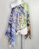 Elements Poncho displayed on a mannequin, styled over one shoulder showing lightweight flowing fabric
