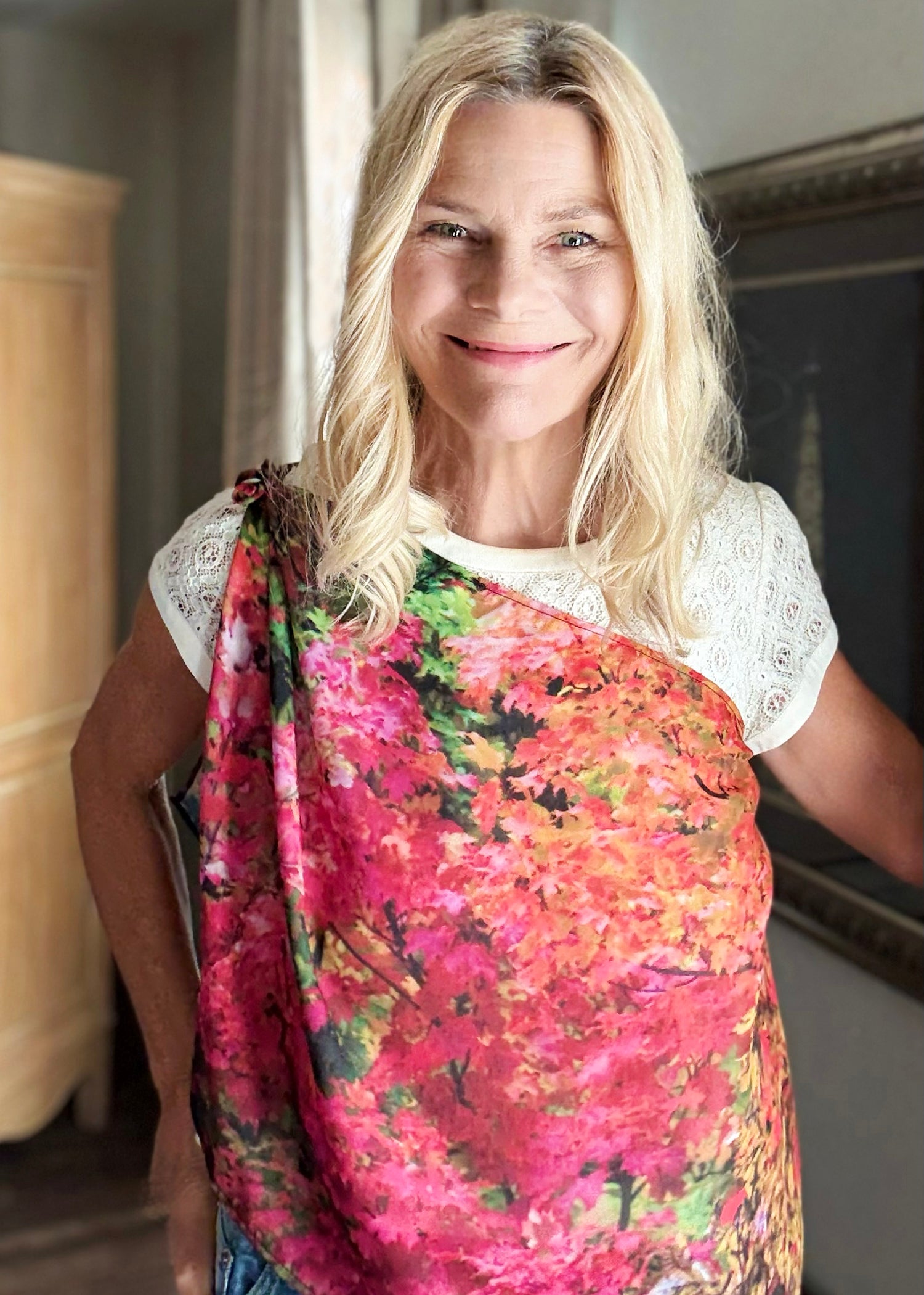 Fall Color Scarf worn draped across the body over one shoulder, showing red, orange, and gold tones