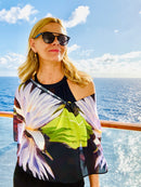 Lotus Scarf with signature pre-tied design, draped off one shoulder showing lotus flower imagery and lightweight flowing fabric