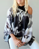 Front view of Orchid Poncho with slip-over design, worn off one shoulder showing black-and-white abstract artwork with lightweight flowing fabric