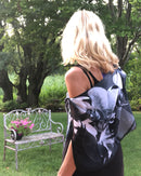 Back view of Orchid Scarf showing black-and-white orchid artwork and signature pre-tied design draped over the shoulders