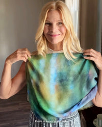 Ombré Scarf styling demonstration showing signature pre-tied design draped over shoulders and styled as neckerchief with green gradient abstract artwork and lightweight fabric flow