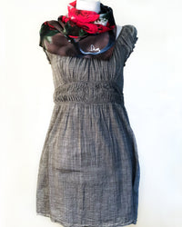Roses Scarf displayed on mannequin styled as a neck wrap, showing red rose artwork and lightweight fabric texture