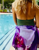 Royal Scarf styled as a sarong, showing fluid movement and abstract floral artwork in a resort setting.