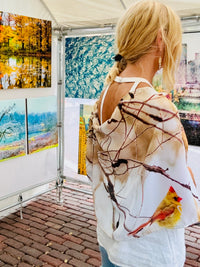 Back view of cardinals print lightweight scarf with signature pre-tied design, showing female cardinal artwork with fluid drape and fabric flow