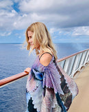 Side view of Coleus Poncho with slip-over design, styled over one shoulder showing lightweight fabric movement in purple and blue tones