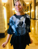 Orchid Scarf featuring original black-and-white orchid artwork, styled off one shoulder with a signature pre-tied design for elegant drape