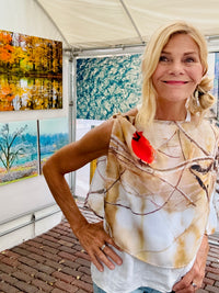 Cardinals print scarf with lightweight fabric worn draped showing a red cardinal among winter branches