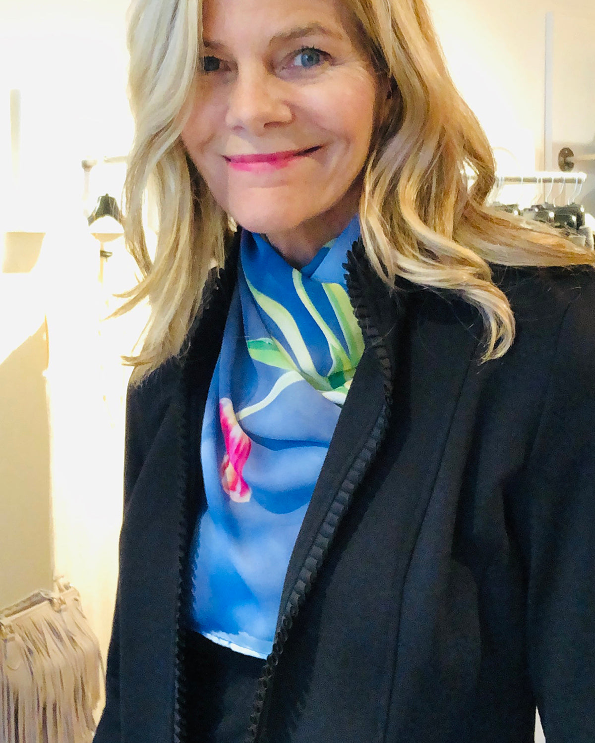 Tulips Scarf styled at the neck under a black jacket, highlighting blue tones with red tulip accents