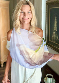 White Tulips Scarf draped off one shoulder, featuring soft white tulip artwork and lightweight flowing fabric