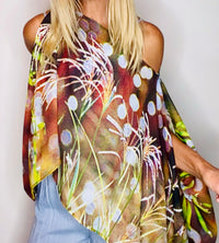 Close-up of Sparkle Poncho earth tone shimmer design with lightweight fabric flowing in movement